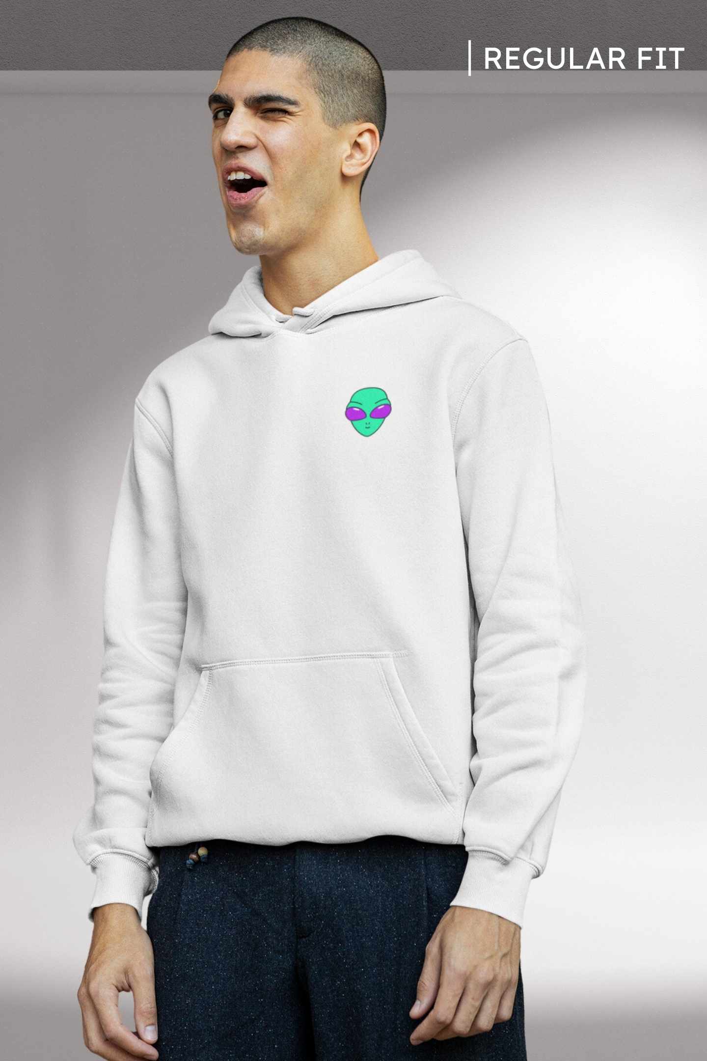 Alienhead Hoodie in white, front view worn by model showcasing small,  bold alien graphic and relaxed fit